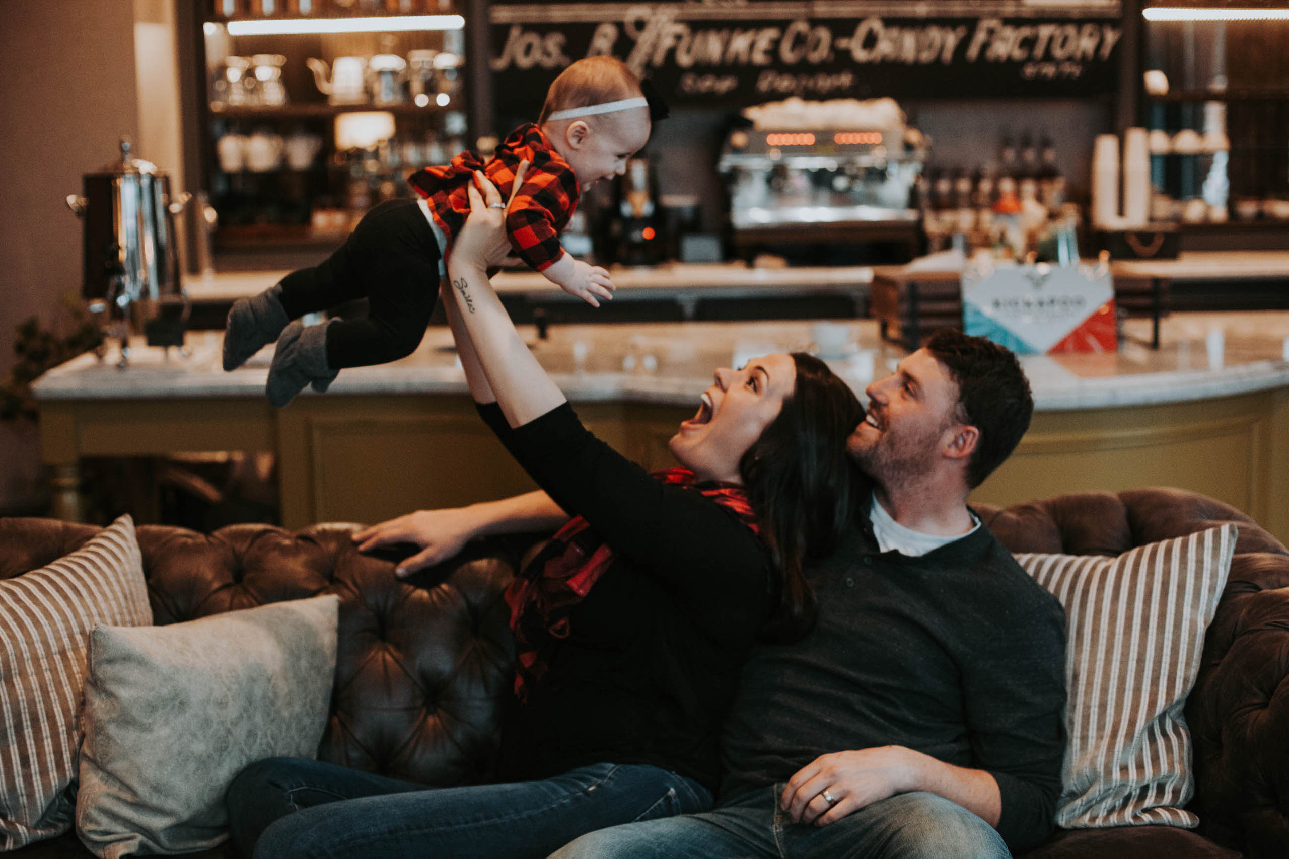 Mom and dad playing with baby in The Parlour